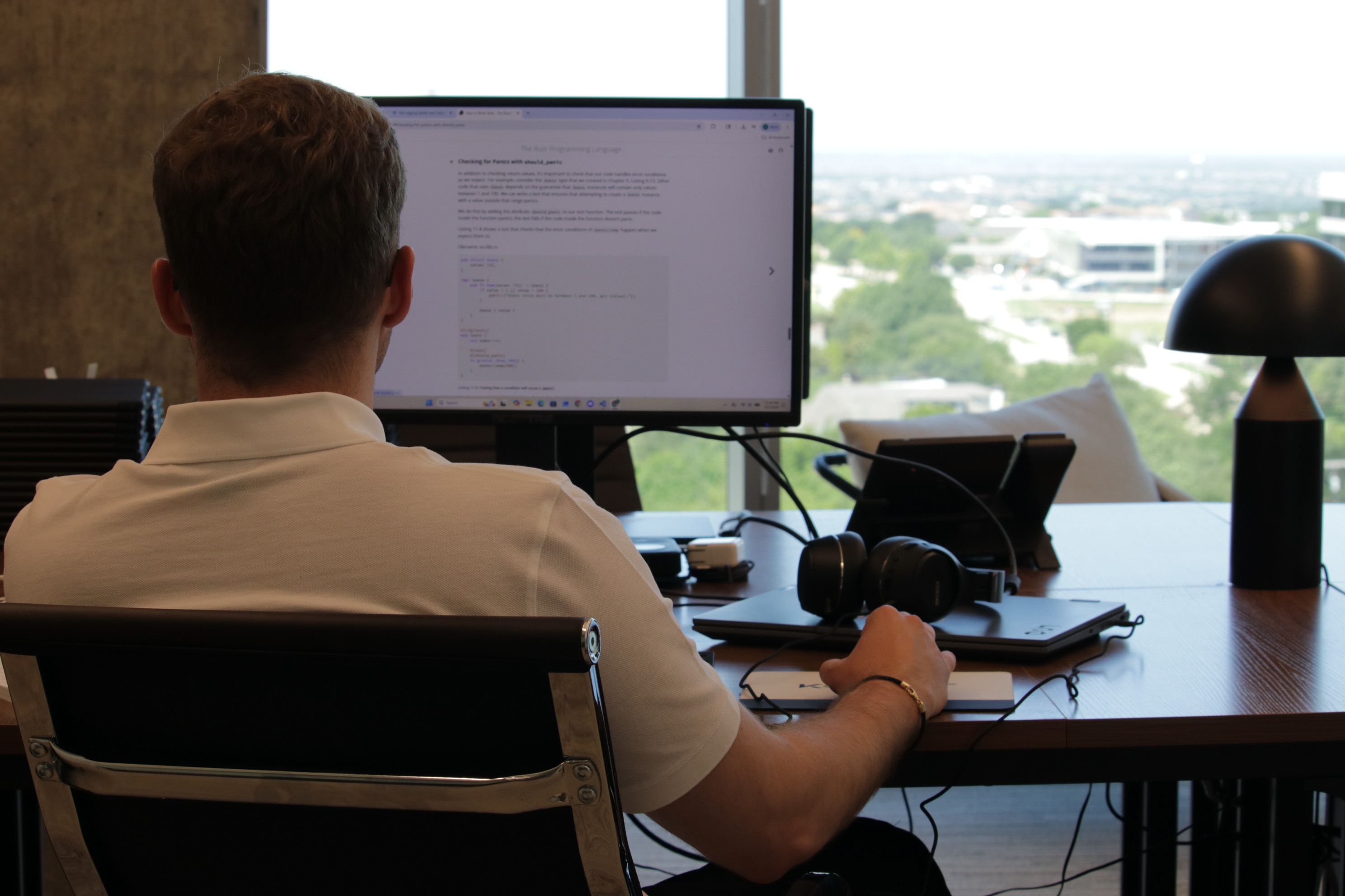 Developer working at a desk overlooking the city
